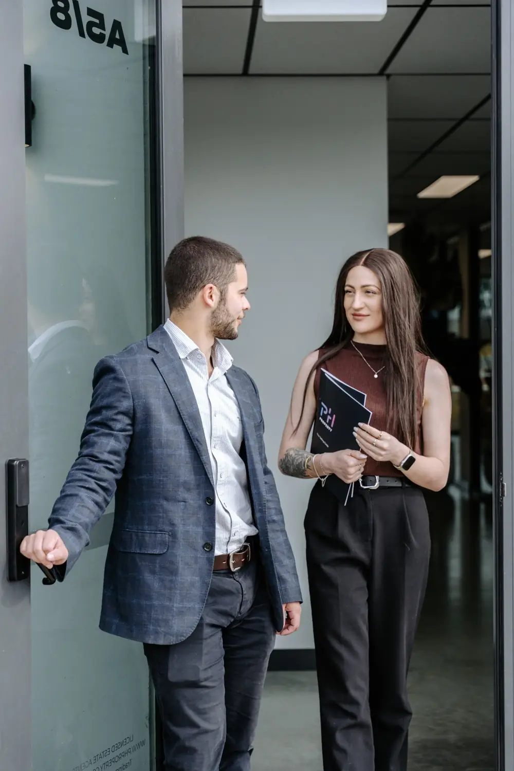 A PH Property agent walking a client through the office
