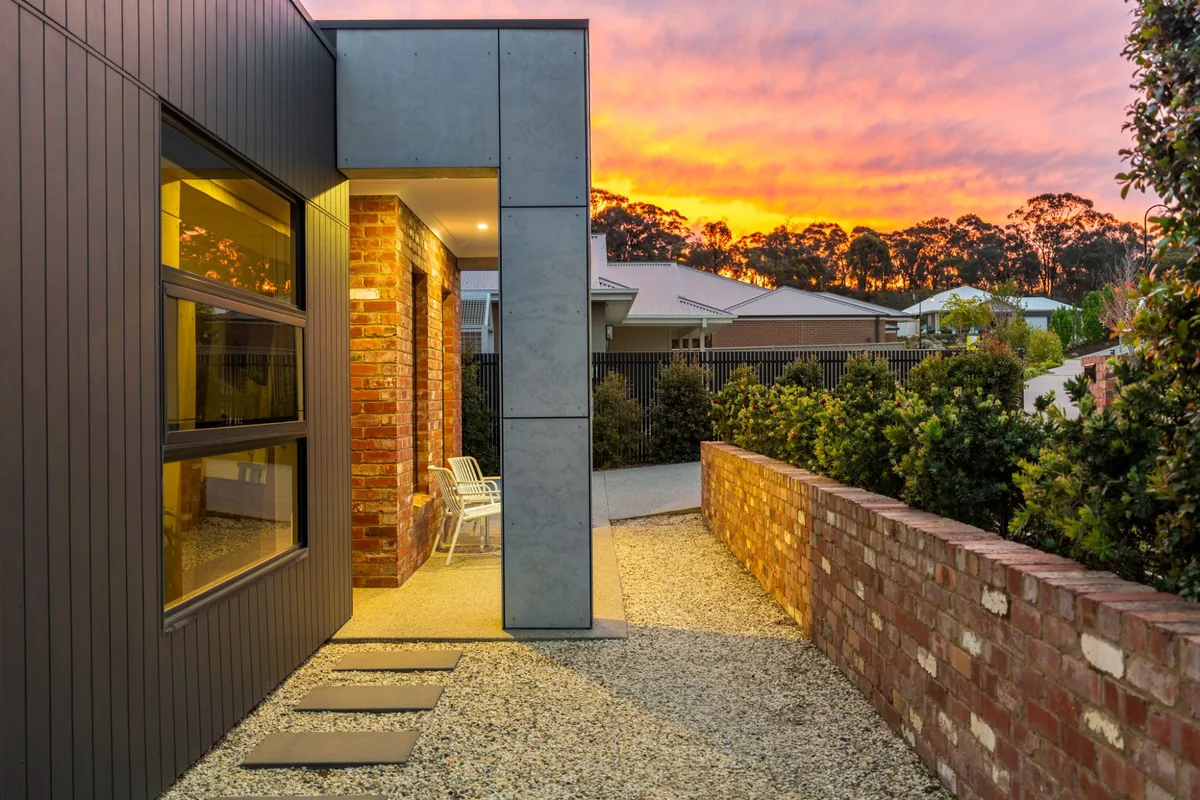 Front entry with brick and concrete panel facade at sunset at 16 Brooklyn Drive, Golden Square
